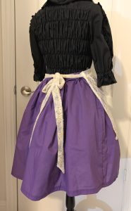 photo of back view of mannequin with lacy apron tied in the back