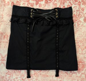 finished black skirt upcycled from a men's shirt with corset lacing and lace trim lingerie details
