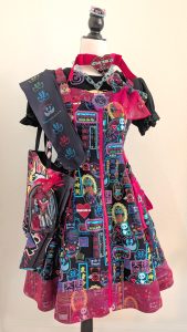Meta's Cyber Neon Girl black jumperskirt coord on a mannequin, complete with tote bag and handmade jewelry