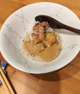 photo of salmon and daikon slices on a bed of shirataki noodles