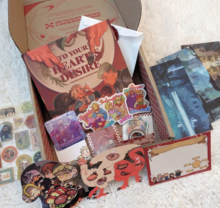 Dungeon Meshi fanzine cookbook with the full bundle of merch!