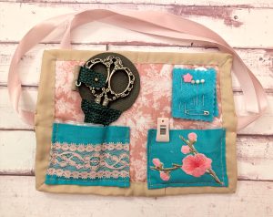 nouveau husswif laid flat opened to show it filled with sewing supplies