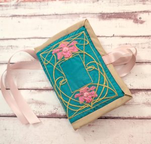 the front of the embroidered husswif, with design patterened by sewstine