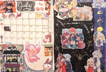 photograph of bullet journal spread for July 2026 featuring a collage of traditional Japanese festival stickers and stationary, also Chinese Genshin fanart stickers on a night sky hand-doodled background