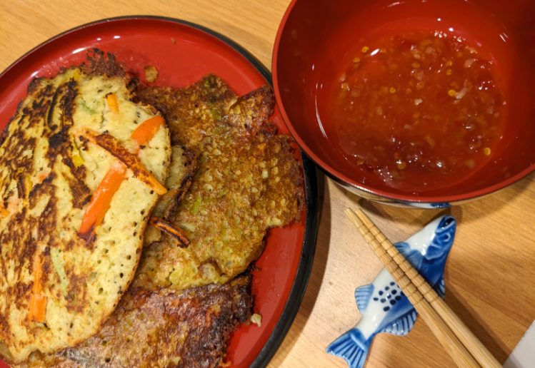 photograph of split pea korean style pancakes with vegetables and sweet chili sauce
