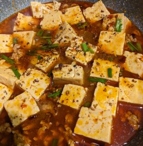 photo of mapo tofu with ground pork in a large pan
