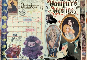 photograph of October 2025 bullet journal monthly calendar spread, featuring gothic lolita characters, witchy cats and half-vampires