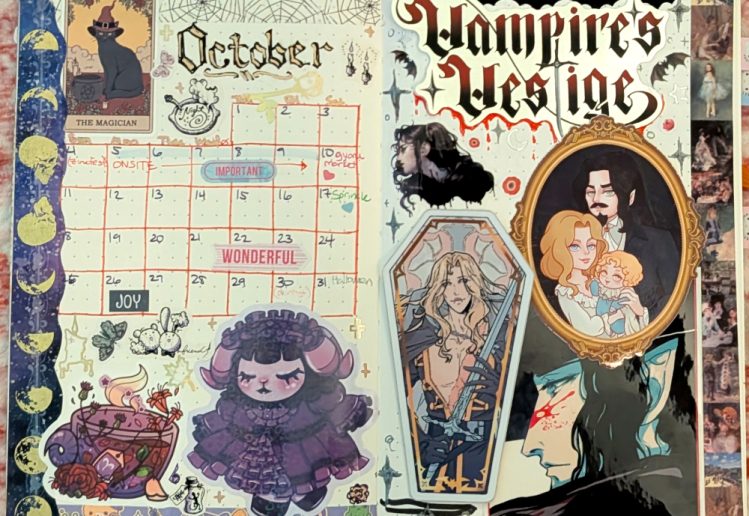 photograph of October 2025 bullet journal monthly calendar spread, featuring gothic lolita characters, witchy cats and half-vampires