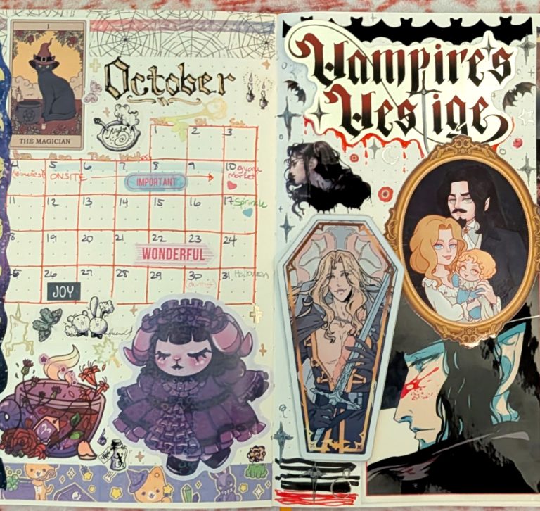 photograph of October 2025 bullet journal monthly calendar spread, featuring gothic lolita characters, witchy cats and half-vampires