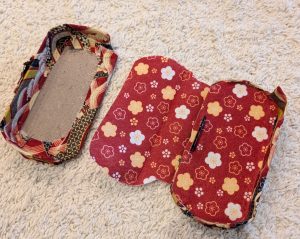 PSP case with the covers glued on, and the felt lining placed on one side, ready to be completed