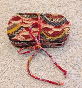 photograph of completed PSP custom case project, with cord holding it closed
