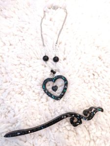 black glittery resin heart shape pendant necklace and a hairstick of the same material
