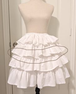 white cotton muslin ruffly underskirt, with uneven ruffle hem circled