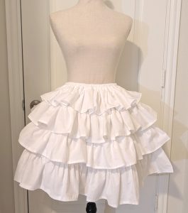 white cotton muslin ruffly underskirt, with the uneven ruffles fixed