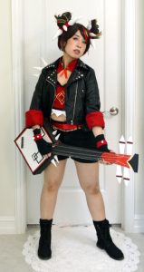 me wearing Xinyan's 2022 concert cosplay holding my handmade prop guitar