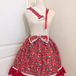photo of handmade ruffle skirt, lace-trimmed bow, lace trimmed headdress and lacy scrunchies from a bright red strawberry print cotton fabric