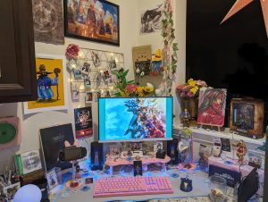 photograph of PC setup featuring pink Razer accessories and Final Fantasy Tactics, 7 and 9 official and fan merch.