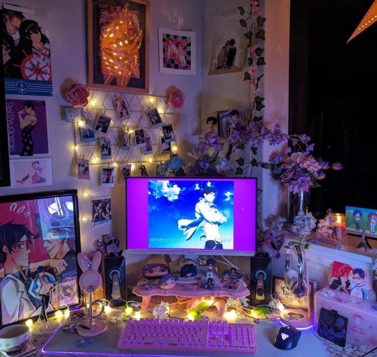 photo of PC setup with pink and purple florals and fanart and official merch of Rei Ryuugazaki (and Rin Matsuoka) from Free! anime