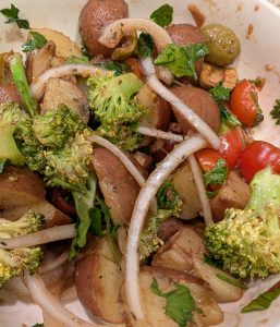 Italian style potato salad with various vegetables and dressing