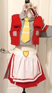 photograph of bishoujo Starscream cosplay on a mannequin with a white apron and frilly headdress decorated as a crown