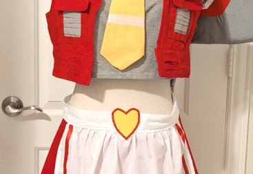 photograph of bishoujo Starscream cosplay on a mannequin with a white apron and frilly headdress decorated as a crown