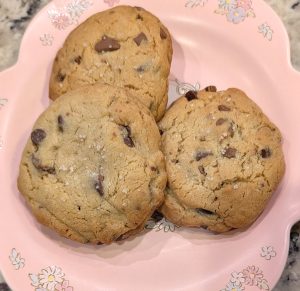 photo of 3 chocolate chip cookies topped with sea salt on a pink My Melody plate