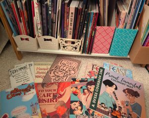 photograph of handmade zines, published fan anthologies, and Japanese doujinshi