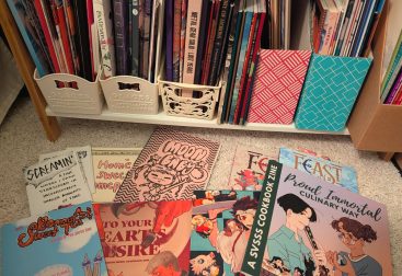 photograph of handmade zines, published fan anthologies, and Japanese doujinshi